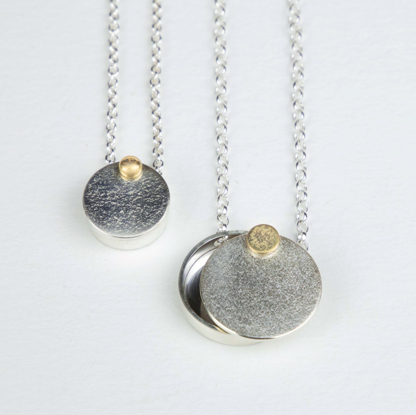 Midcentury moon lockets in larger size with textured gold rivet.