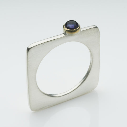A square silver ring with a pretty cabochon (4mm) set in gold.