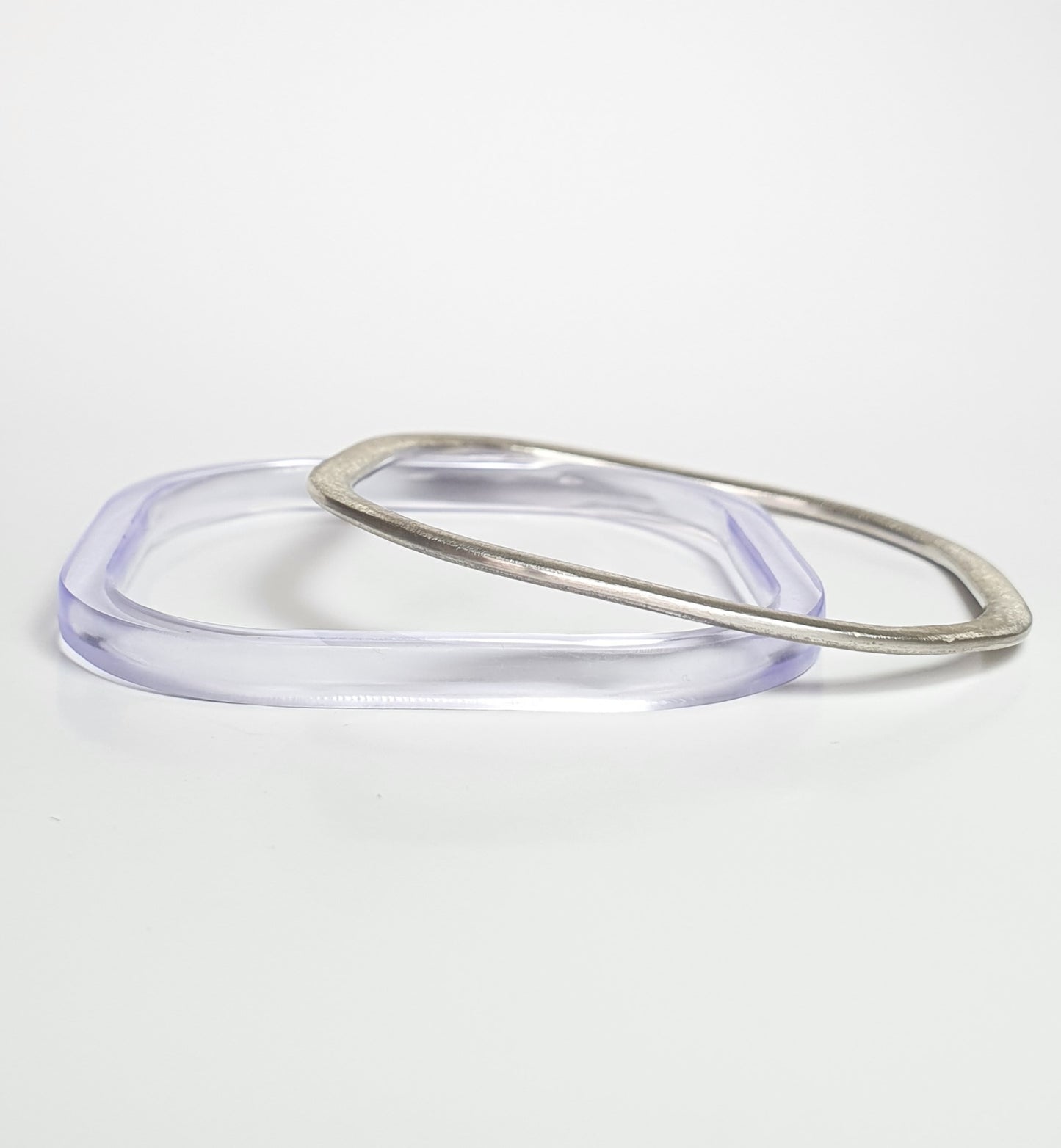 Square bangles in silver and in chunky violet perspex Barbara Spence Jewellery