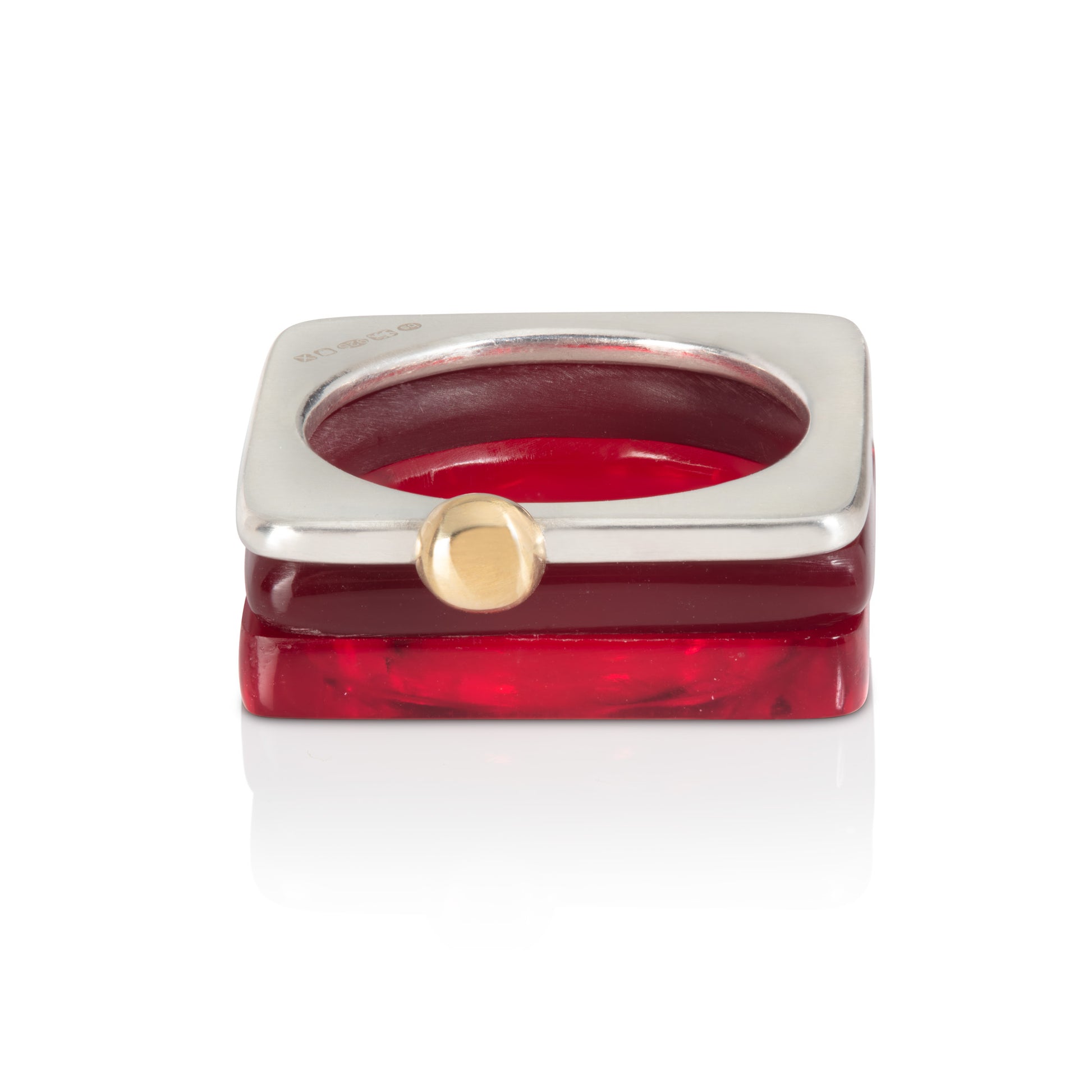Set of square rings featuring (from bottom) dark red, chocolate brown, silver with gold ball. BarbaraSpence.co.uk