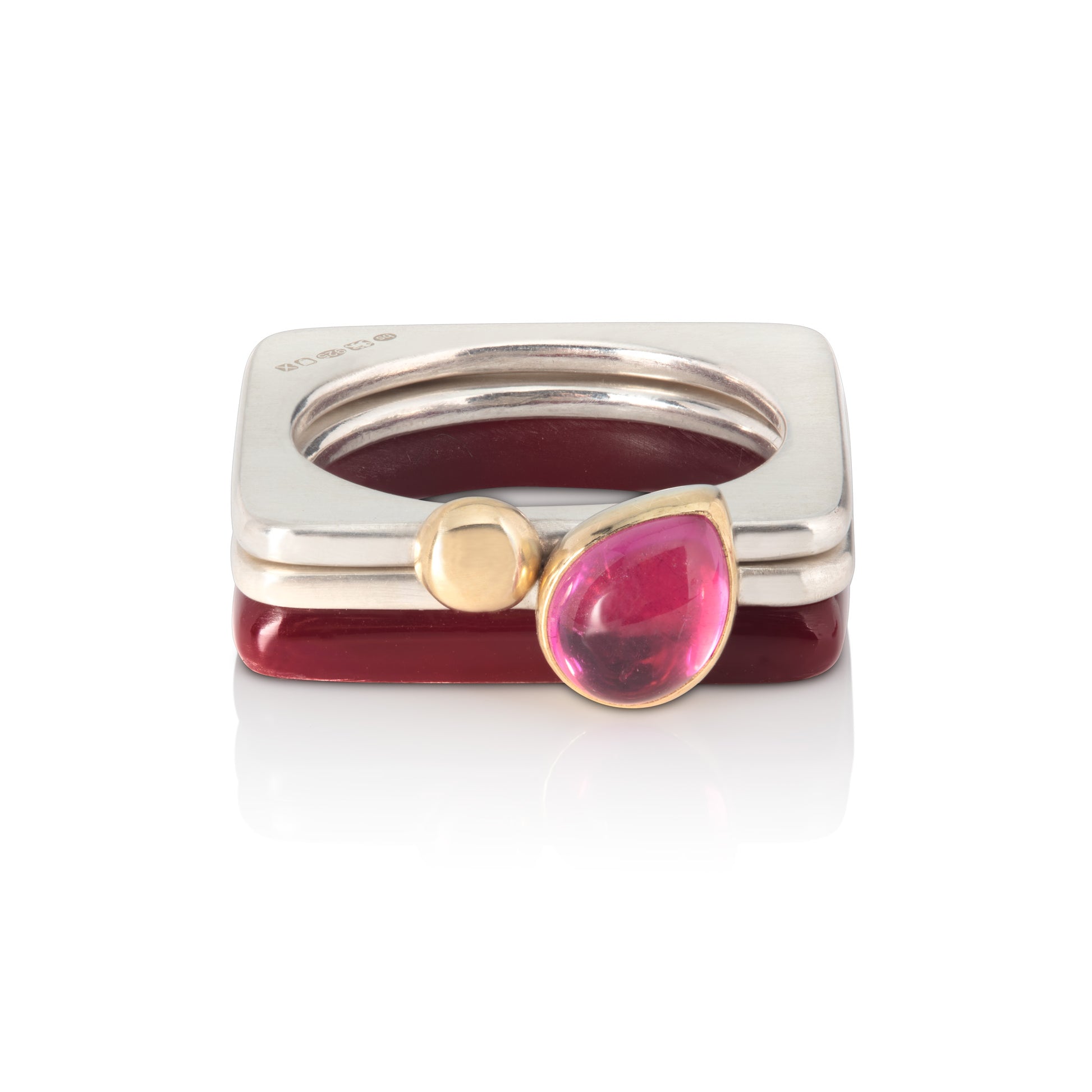 Set of square rings featuring (from bottom) chocolate brown, silver with pink tourmaline and silver with gold ball. BarbaraSpence.co.uk