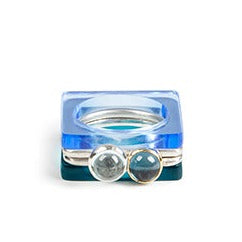 Set of square stacking rings: silver with London blue topaz set in gold, silver with pale topaz set in silver cup, perspex in Neptune and Azure
