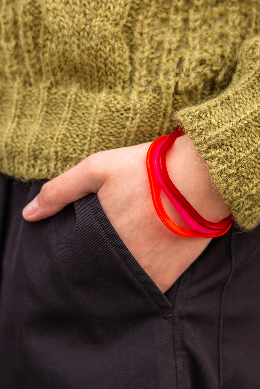 Square perspex bangles in Mars red, pink and dark red, modelled by Holly www.barbaraspence.co.uk