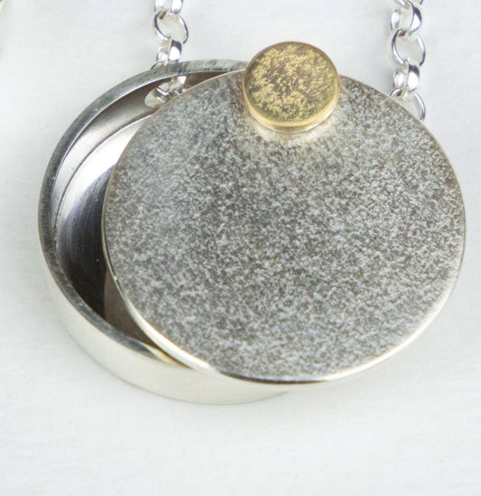 Midcentury moon lockets in larger size with textured gold rivet.