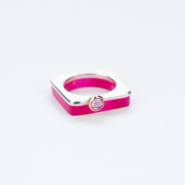 A square silver ring with a pretty cabochon set in gold.