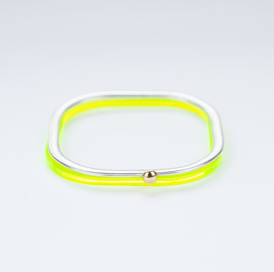 Square silver bangle with gold ball stacked with acid green acrylic bangle www.barbaraspence.co.uk