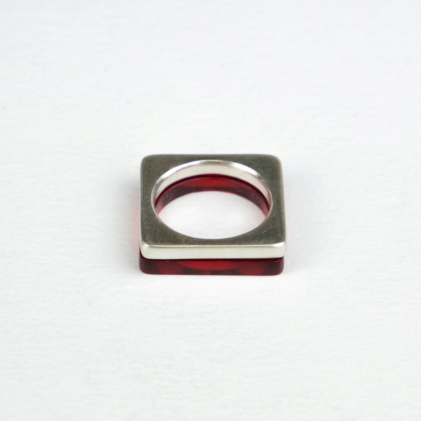 Dark red perspex ring stacked with heavy square silver ring www.barbaraspence@hotmail.co.uk