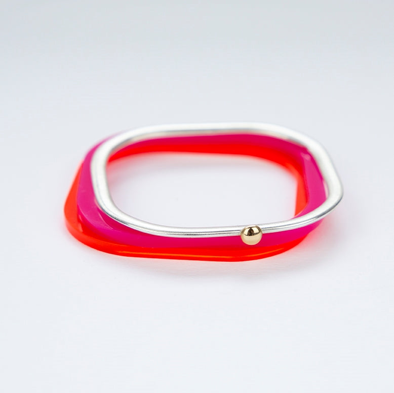 Square silver bangle with gold ball stacked with red acrylic bangles www.barbaraspence.co.uk