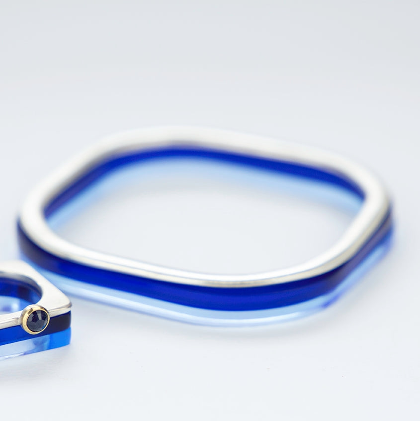 Square silver bangle with brushed texture stacked with 2 blue perspex bangles www.barbaraspence.co.uk